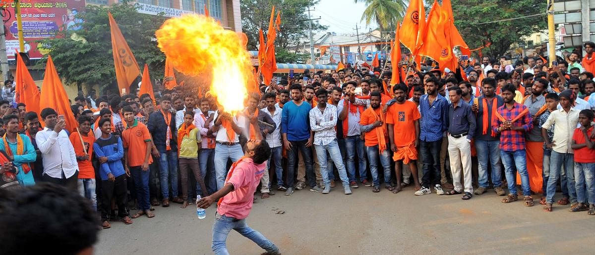 A Datta devotee exhibits a stunt during Shobhayatra in Chikkamagaluru on Friday.