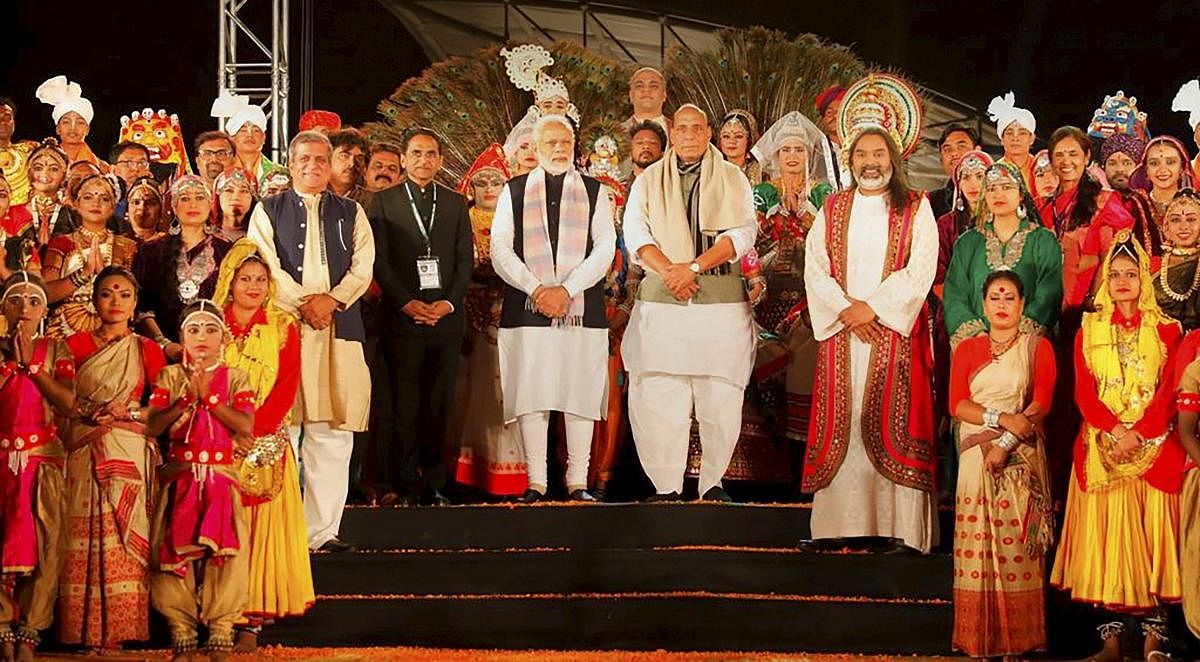 Prime Minister Narendra Modi and Home Minister Rajnath Singh pose for photos with a group of artists, in Kewadiya, Friday, Dec. 21, 2018. (PTI Photo)