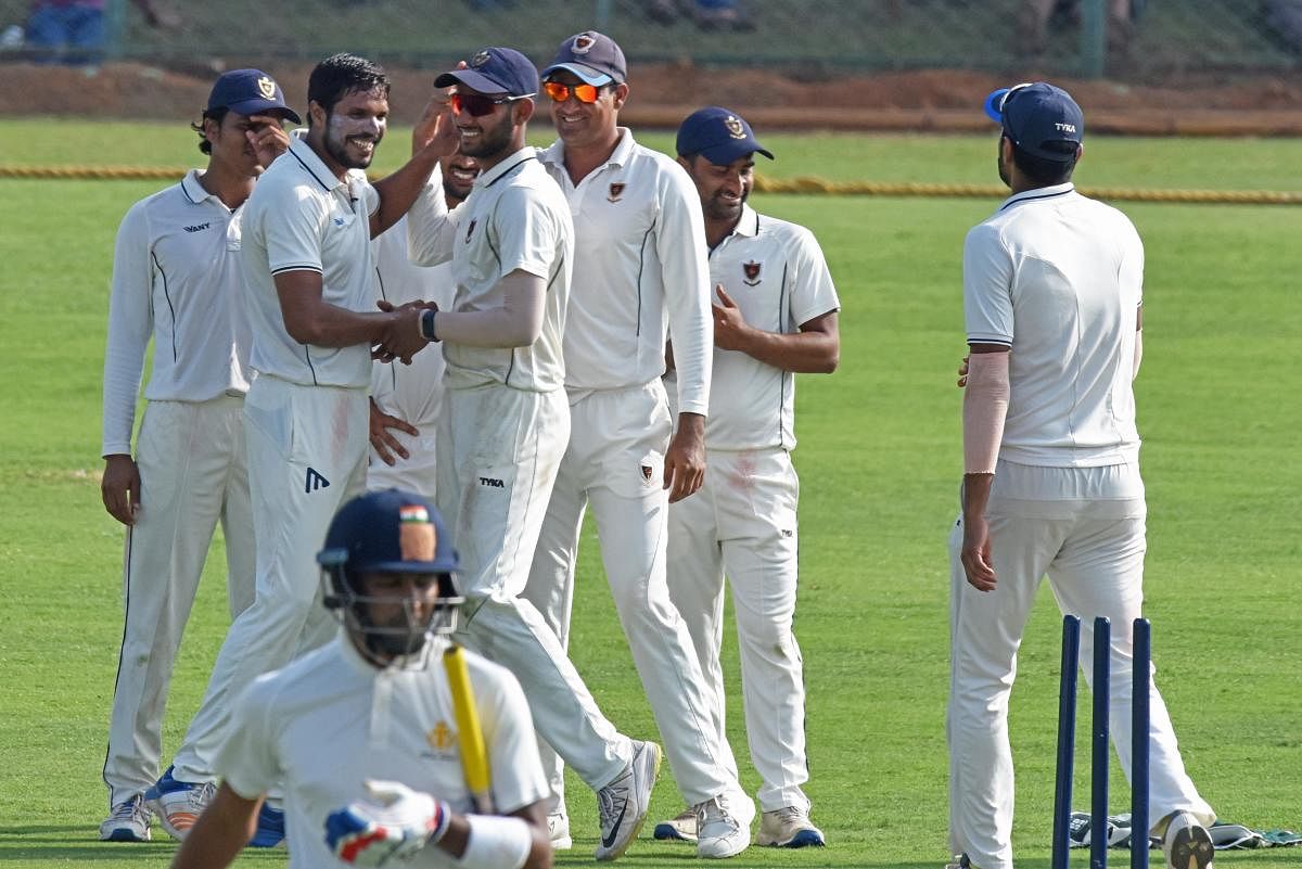 FINE EFFORT: Railways’ Amit Mishra (second from left) celebrates with team-mates after a Karnataka wicket on the opening day of their Ranji Trophy match in Shivamogga on Saturday.DH PHOTO/ S K DINESH