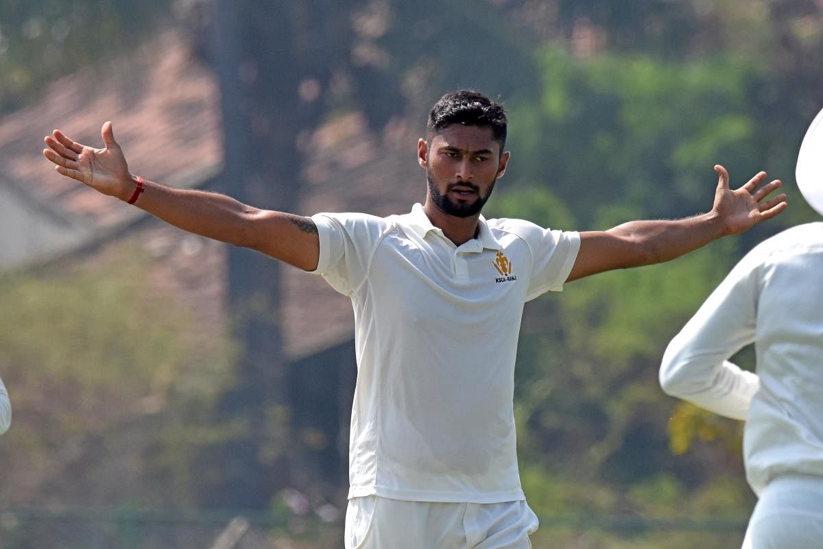HIGH-FLYING: Karnataka’s Ronit More celebrates after taking his second five wicket haul of the season during the game against Railways in Shivamogga on Sunday. The right-arm medium pacer bagged 5/45. DH Photo/ S K Dinesh