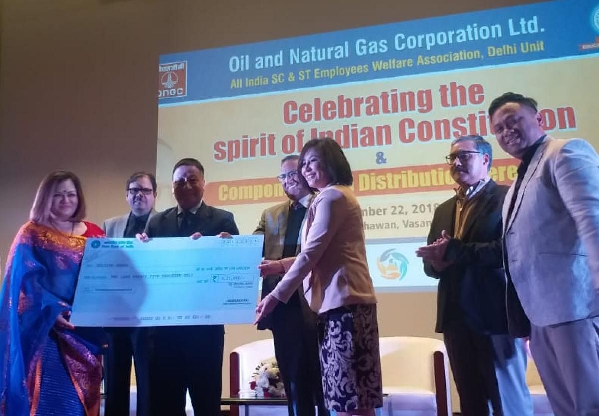 ONGC handing over a cheque to Helping Hands, an NGO, in New Delhi on Saturday. Photo by Robin Hibu, IGP
