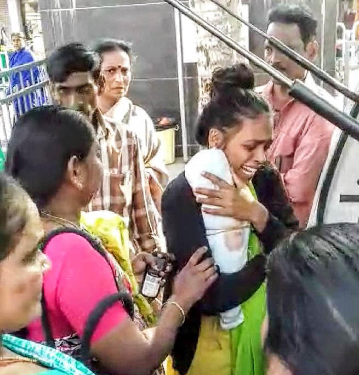 Mother Stella crying with the baby (Toddlers body was hidden under the iron cot along with his toys at Karthik’s house in North Street in Neelasandra.)