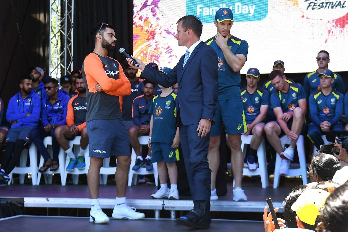 India's captain Virat Kohli (L) and his Australian counterpart Tim Paine (R) are interviewed during a meet the fans event in Melbourne on December 23, 2018, ahead of their third cricket Test match. (AFP Photo)