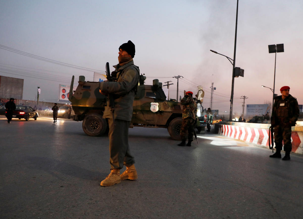 Afghan security forces stand guard at the site of an attack in Kabul, Afghanistan. (REUTERS)