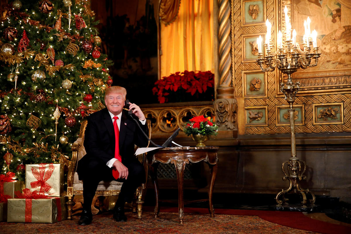 US President Donald Trump participates in NORAD (North American Aerospace Defense Command) Santa Tracker phone calls with children at Mar-a-Lago estate in Palm Beach, Florida, U.S., December 24, 2017. REUTERS