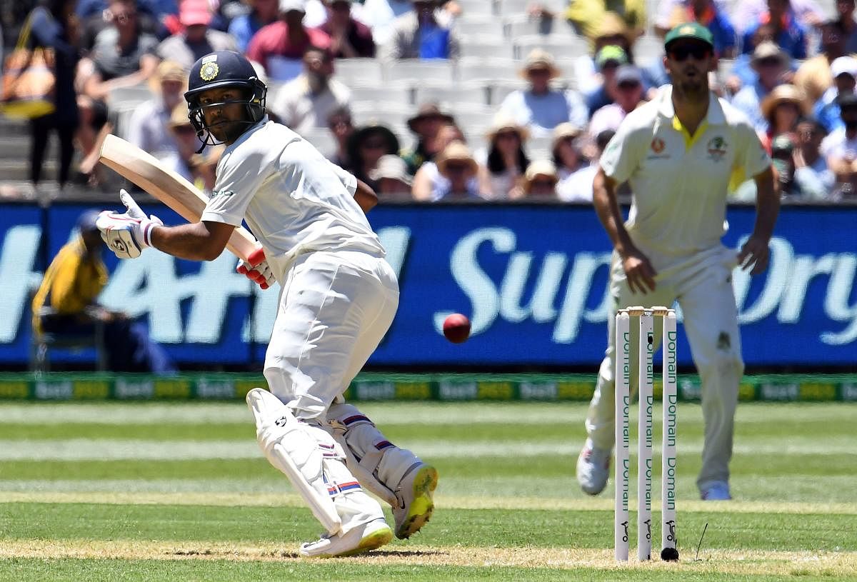 India's batsman Mayank Agarwal (L) plays a shot during day one of the third cricket Test match between Australia and India in Melbourne on December 26, 2018. (AFP Photo)