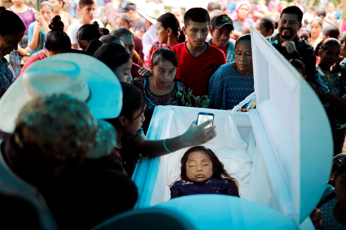 Friends and family gather around the coffin of Jakelin Caal, a 7-year-old girl who handed herself in to US border agents earlier this month and died after developing a high fever while in the custody of US Customs and Border Protection, during her funeral