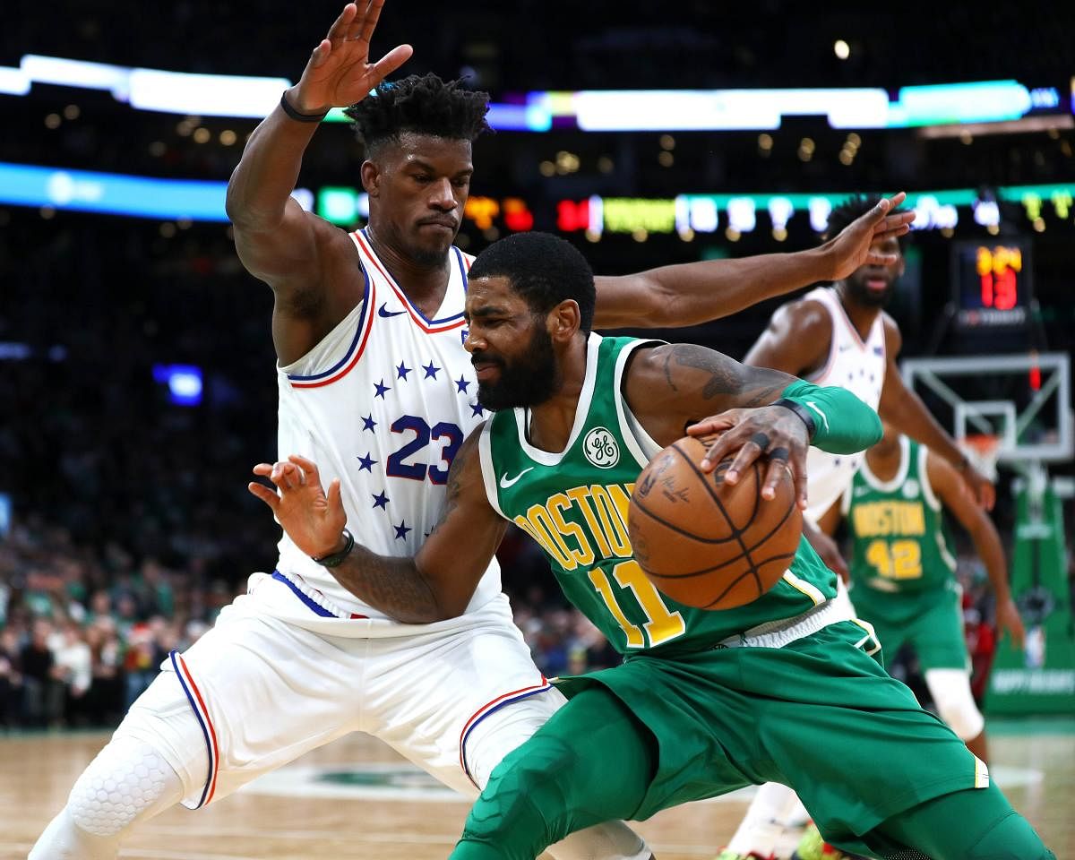 BOSTON, MASSACHUSETTS - DECEMBER 25: Kyrie Irving #11 of the Boston Celtics drives to the basket on Jimmy Butler #23 of the Philadelphia 76ers during the fourth quarter of the game at TD Garden on December 25, 2018 in Boston, Massachusetts. NOTE TO USER: User expressly acknowledges and agrees that, by downloading and or using this photograph, User is consenting to the terms and conditions of the Getty Images License Agreement. Omar Rawlings/Getty Images/AFP