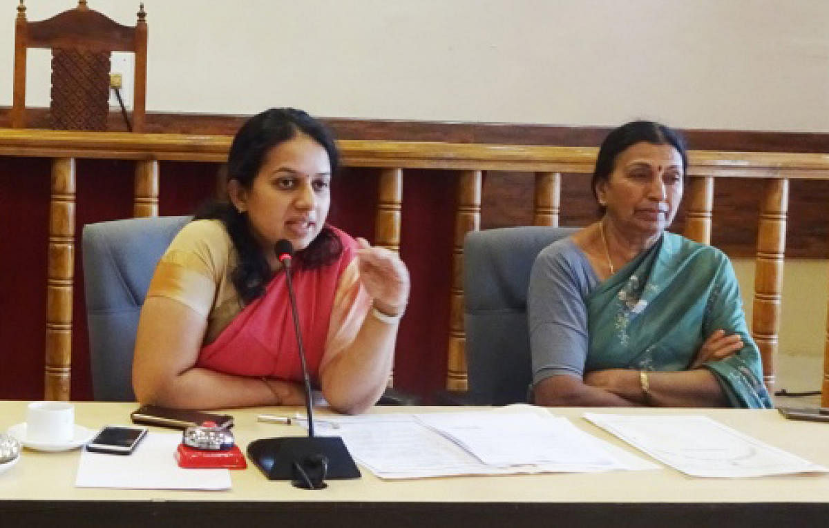 Deputy Commissioner P I Sreevidya and Madikeri City Municipal Corporation President Kaveramma Somanna take part in a meeting at the DC's office on Wednesday.