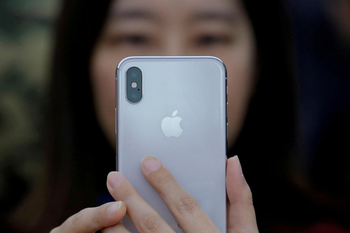 An attendee uses a new iPhone X during a presentation for the media in Beijing, China, on October 31, 2017. REUTERS