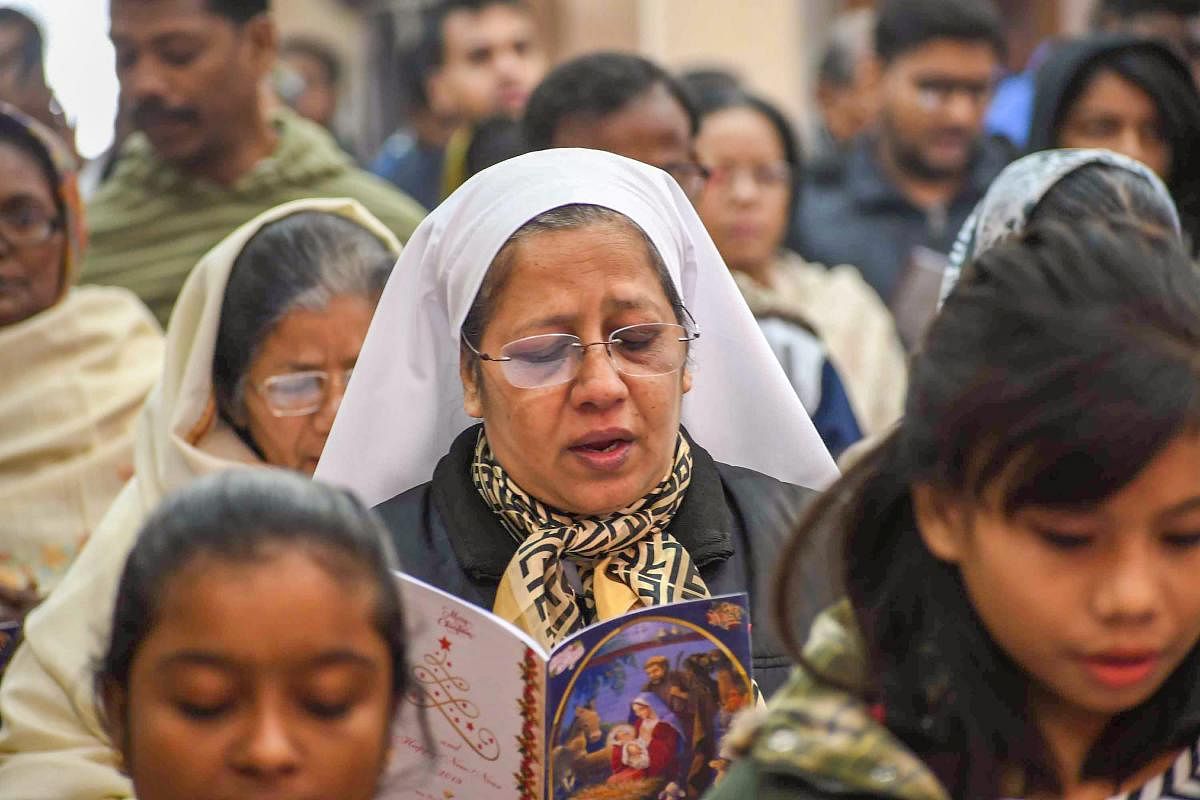 Devotees attend the mass prayers on the occasion of Christmas at Katholik Church, in Patna on Dec 25, 2018. PTI