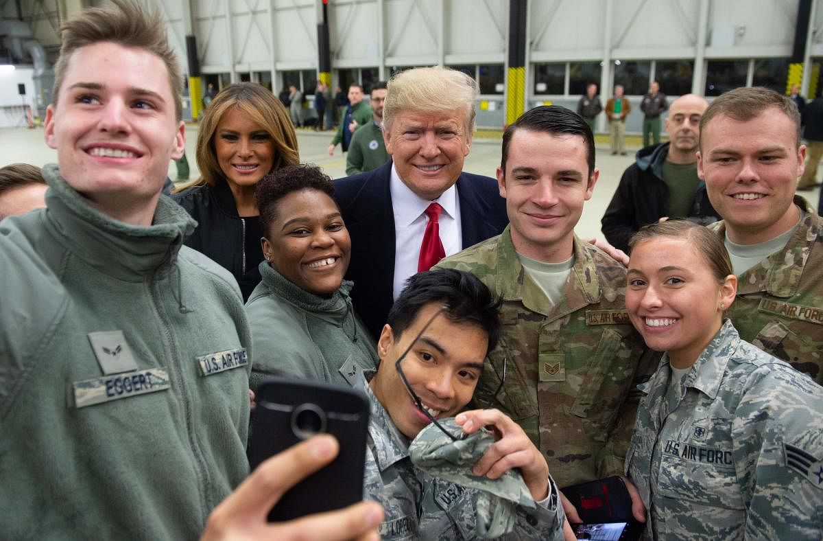 US President Donald Trump and First Lady Melania Trump greet members of the US military during a stop at Ramstein Air Base in Germany, on December 27, 2018. (AFP Photo)
