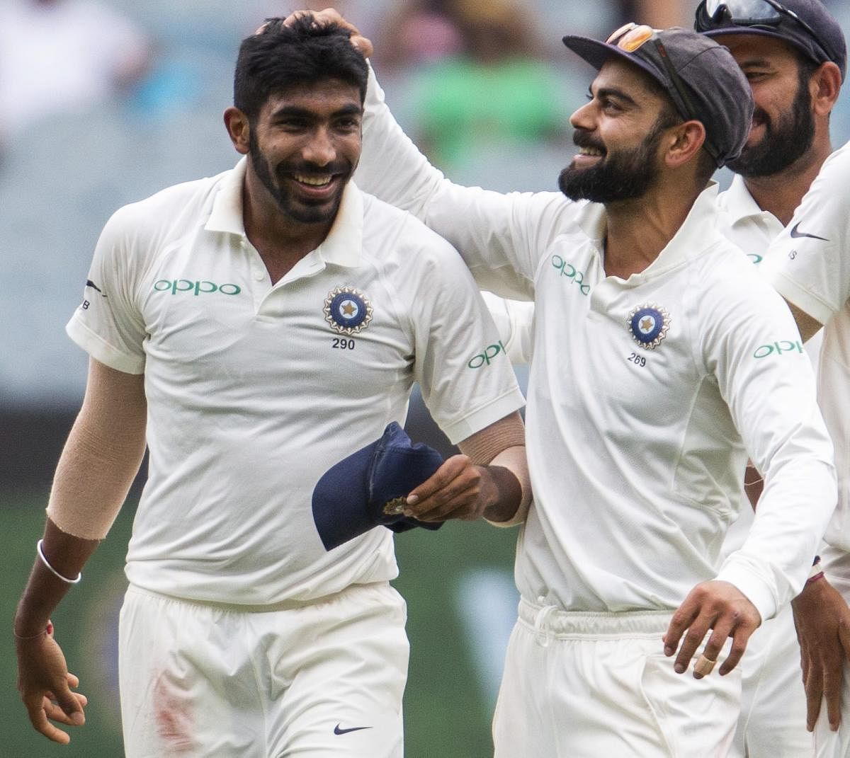 WELL DONE! India's Virat Kohli (right) celebrates with Jasprit Bumrah the dismissal of Australia's Shaun Marsh. AFP/PTI