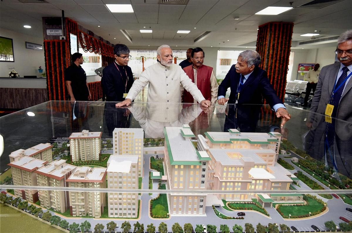 New Delhi: Prime Minister Narendra Modi being explained about the first ever All India Institute of Ayurveda after it was dedicated to the nation on the occasion of 2nd Ayurveda Day, in New Delhi on Tuesday. Minister of State for AYUSH (Independent Charge), Shripad Yesso Naik is also seen. PTI Photo / PIB