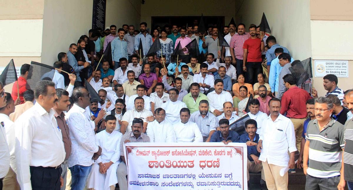 Members of Kodagu District Roman Catholic Association stage a protest in front of the DC’s office in Madikeri on Friday. 