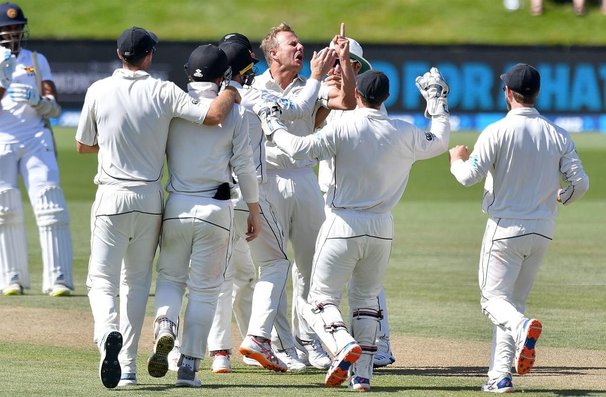 New Zealand's Neil Wagner (centre) celebrates with team-mates after dismissing Sri Lanka's Dinesh Chandimal on Saturday. AFP