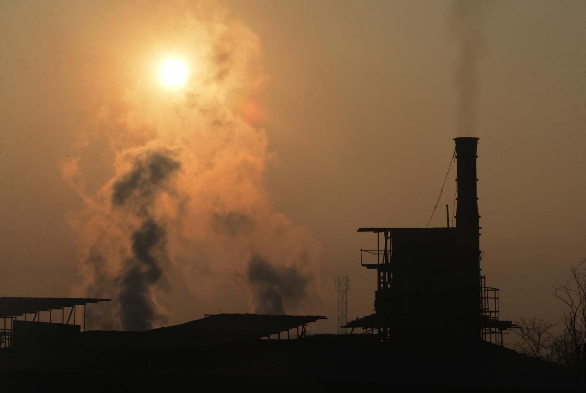 Smoke rises from a factory chimney on the outskirts of Amritsar on Saturday.(AFP)
