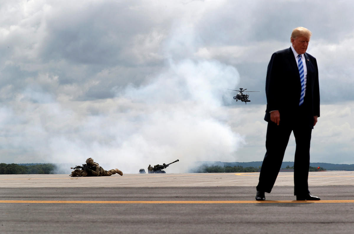 U.S. President Donald Trump observes a demonstration with U.S. Army 10th Mountain Division troops, an attack helicopter and artillery as he visits Fort Drum, New York, U.S., August 13, 2018. Reuters photographer Carlos Barria: "President Trump often talks