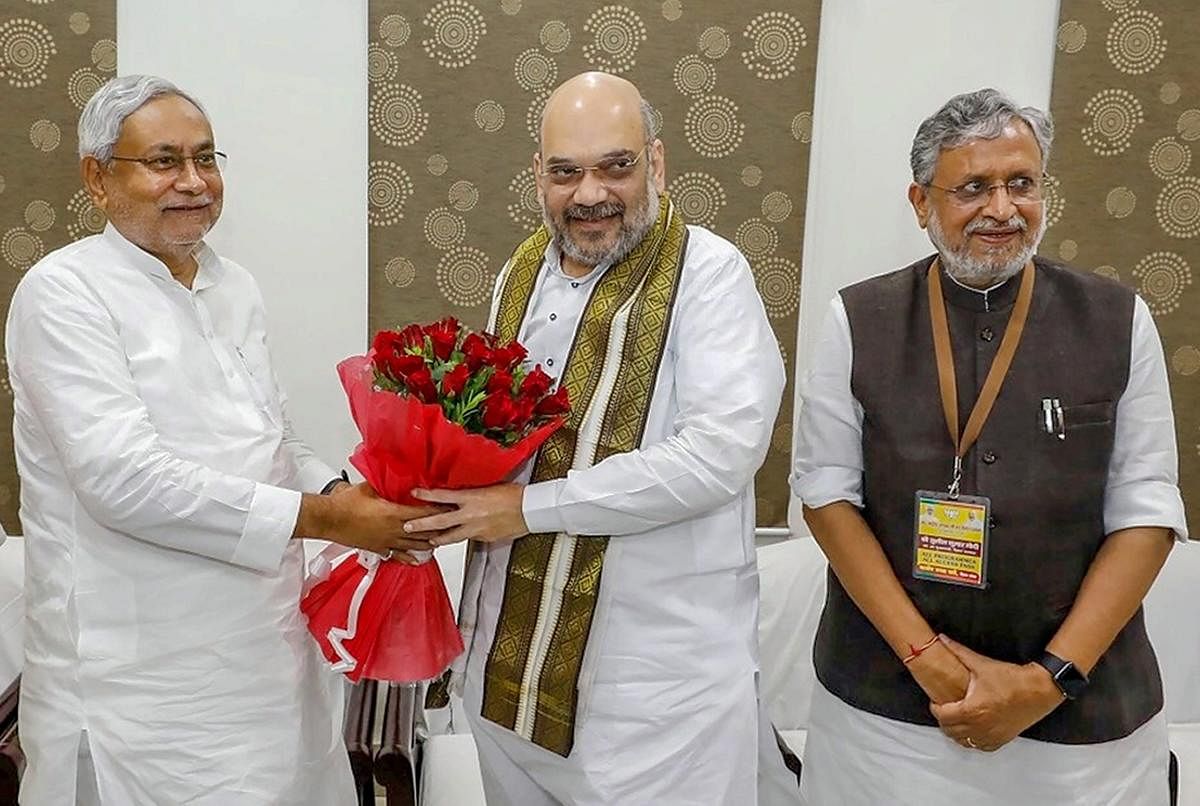 BJP President Amit Shah being greeted by Bihar Chief Minister Nitish Kumar at a breakfast-meeting, in Patna on Thursday, July 12, 2018. (PTI Photo)