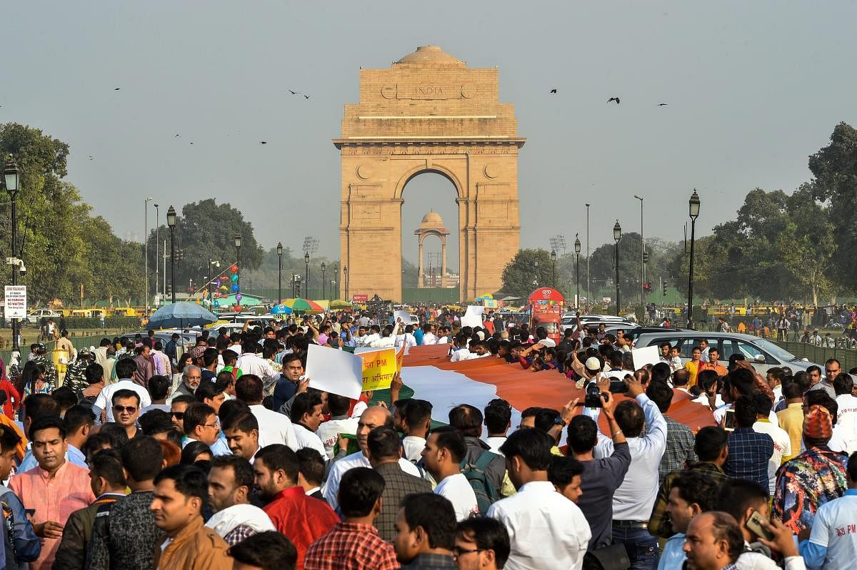 BJP supporters participate in 'Mera PM Mera Abhiman' campaign at India Gate in New Delhi, on Sunday. PTI