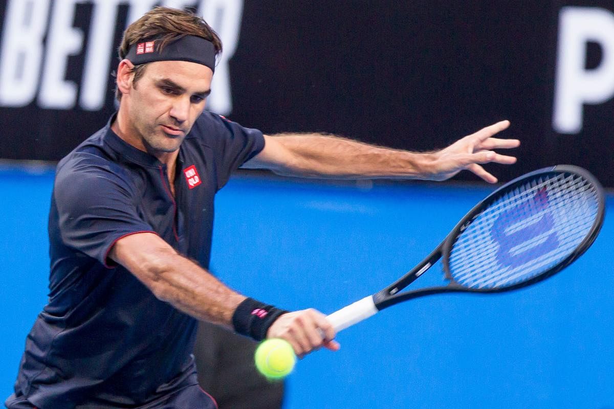 Roger Federer hits a return against Cameron Norrie in the Hopman Cup. AFP