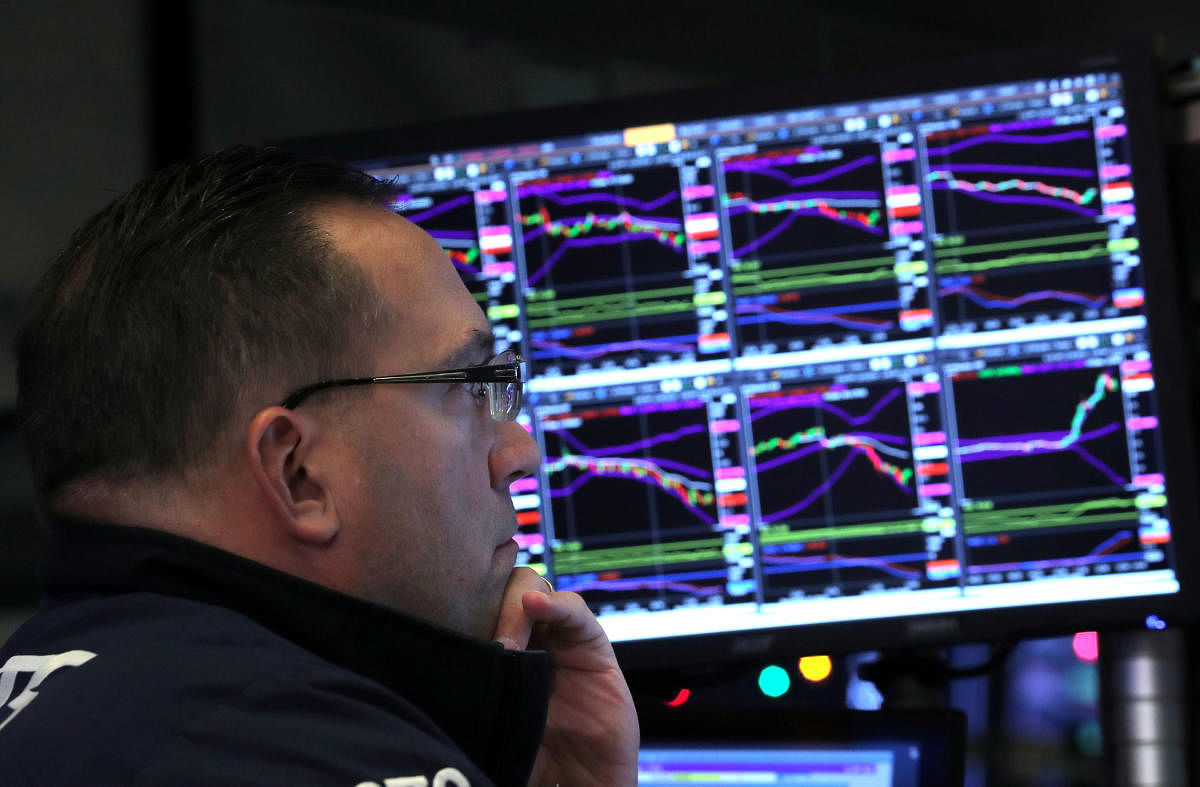 A trader looks at price monitors as he works on the floor at the New York Stock Exchange (NYSE) in New York City. Reuters file photo.