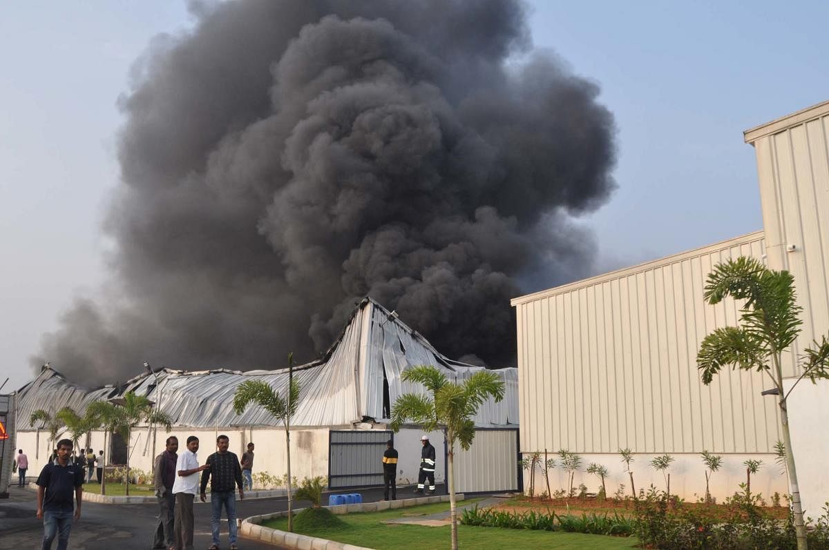 Smoke billows out of the factory at Tandya Industrial Area, in Nanjangud taluk, Mysuru district, on Monday.