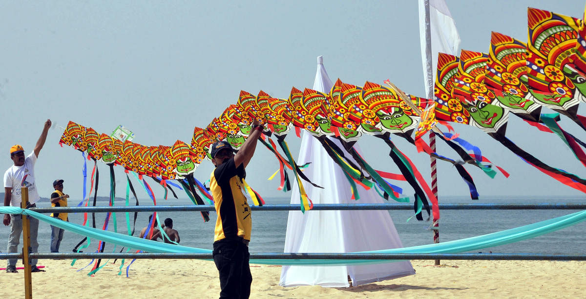 Kite flyers prepare for the festival at Malpe beach on Monday.