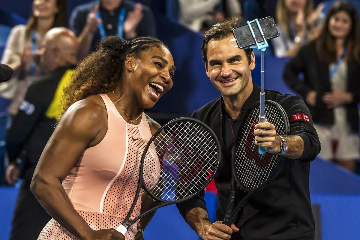 US' Serena Williams (left) and Roger Federer of Switzerland take a selfie after their mixed doubles match in Perth on Tuesday. AFP