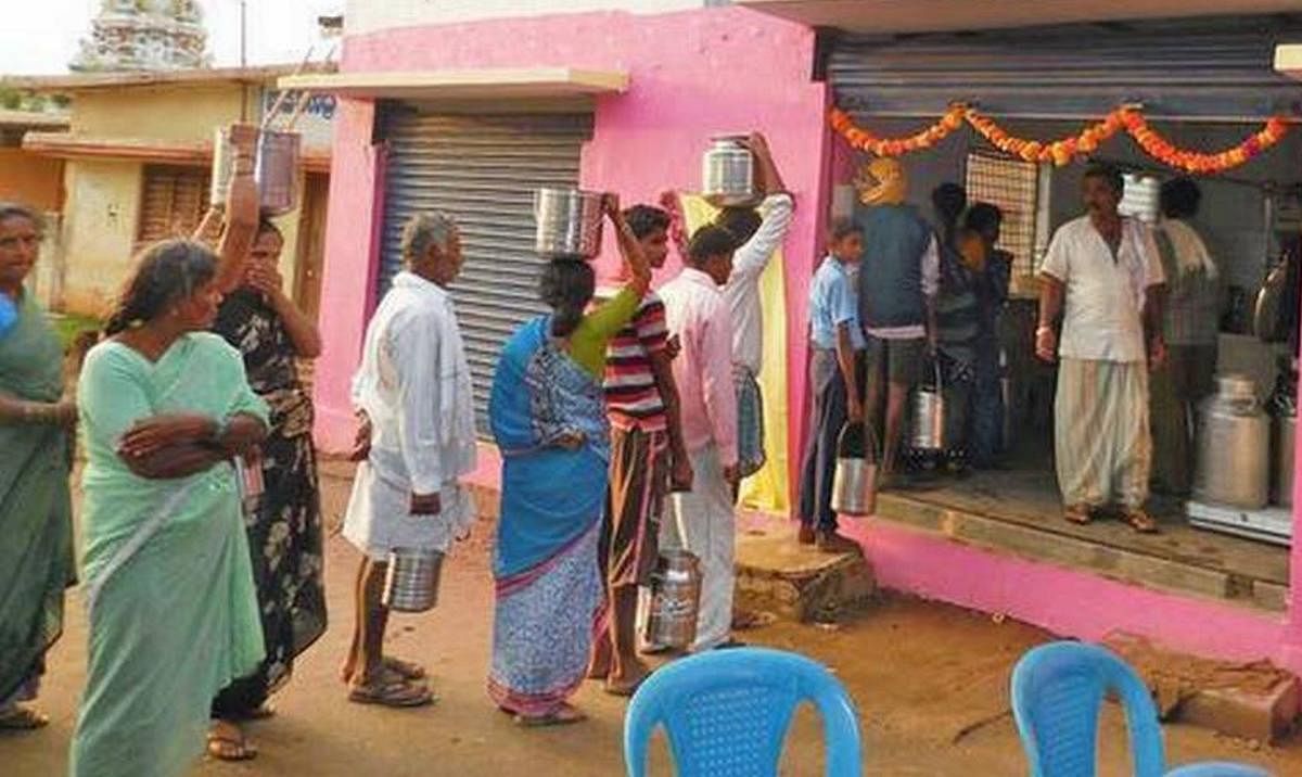 Farmers supply milk to a dairy in a village in Mandya district. DH file photo