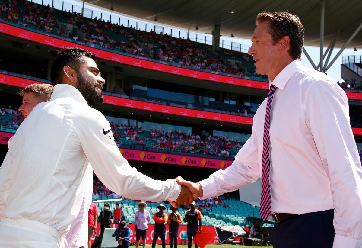 India's captain Virat Kohli (L) shakes hands with former Australian bowler Glenn McGrath before the start of the third day's play of the fourth and final cricket Test between India and Australia at the Sydney Cricket Ground on January 5, 2019. (AFP Photo)