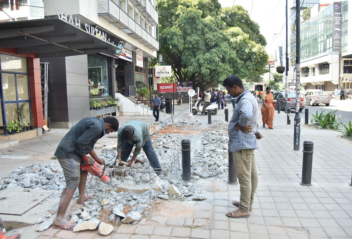 Workers of private company destroying the TenderSURE footpath in front of Shah Sultan building at Cunningham road in Bengaluru on Saturday 27th October 2018. Photo by Janardhan B K
