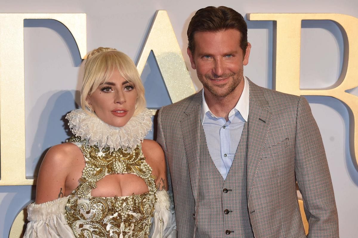 In this file photo taken on September 27, 2018 US singer and actress Lady Gaga (L) and US actor and filmmaker Bradley Cooper pose on the red carpet upon arrival for the UK premiere of the film "A Star is Born" in central London. - Box office hit music rom