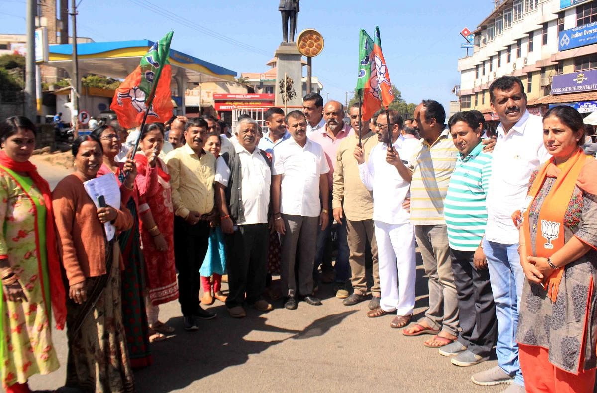 BJP workers stage a protest against the coalition government at General Thimayya Circle in Madikeri on Monday.