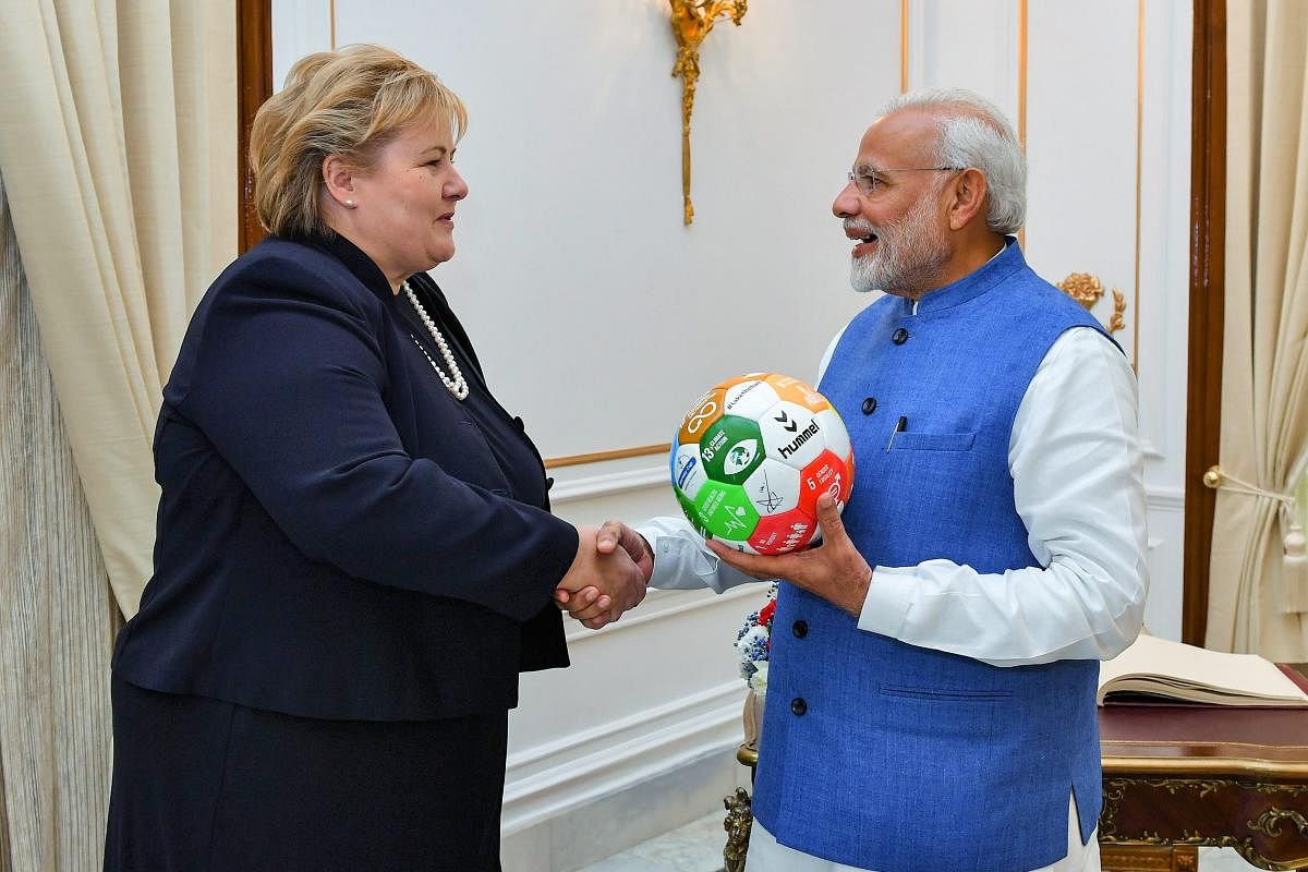 Prime Minister Narendra Modi gifts memento to his Norwegian counterpart Erna Solberg at Hyderabad House, in New Delhi, on Tuesday. PTI