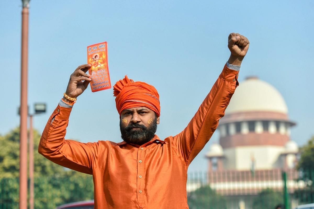 A member of a Hindu group during a protest in support of Ram Temple, near Supreme Court in New Delhi on Thursday. PTI