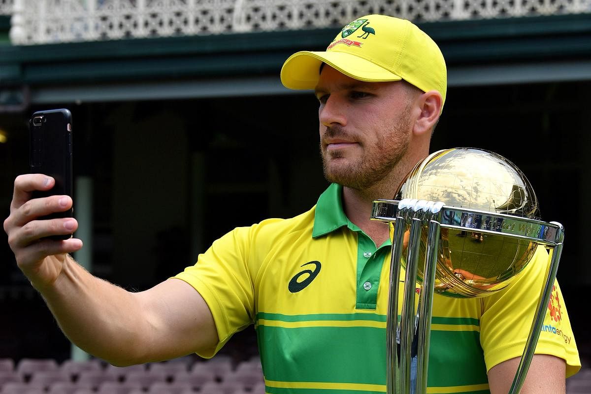 Australia's captain Aaron Finch takes a selfie with the ICC Cricket World Cup trophy in Sydney on Friday. AFP 