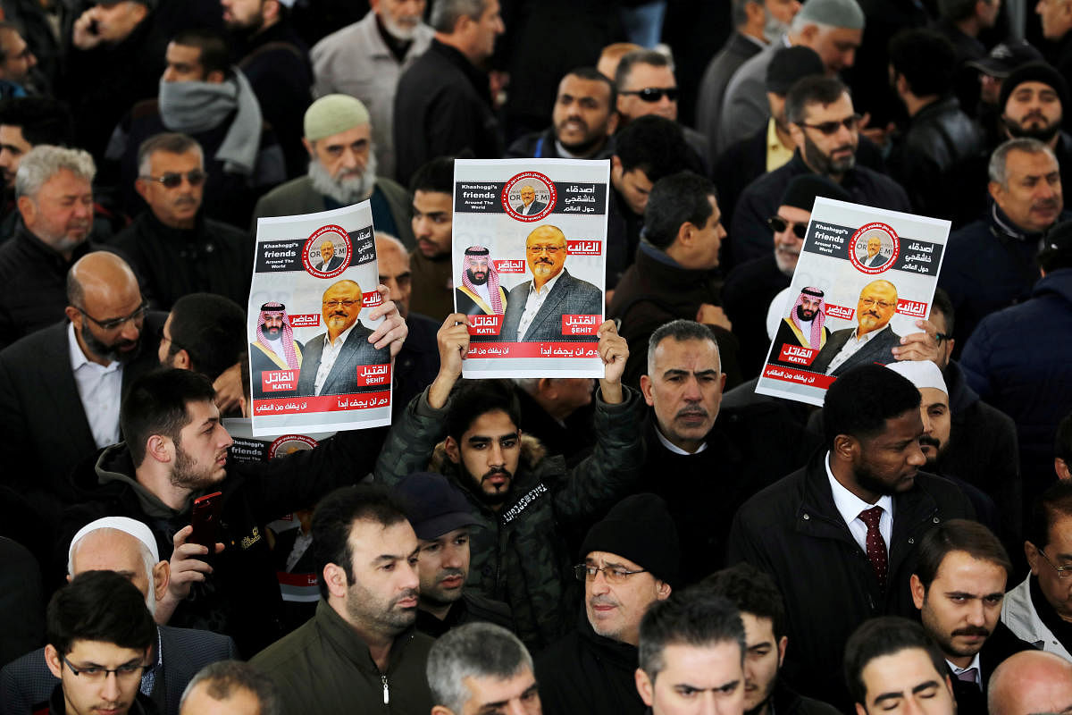 FILE PHOTO: People holding pictures of Saudi journalist Jamal Khashoggi attend a symbolic funeral prayer for Khashoggi at the courtyard of Fatih mosque in Istanbul, Turkey November 16, 2018. REUTERS/Huseyin Aldemir/File Photo