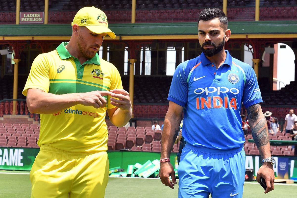 Virat Kohli (R) and Aaron Finch (L) arrive for a media call at the Sydney Cricket Ground in Sydney. AFP.