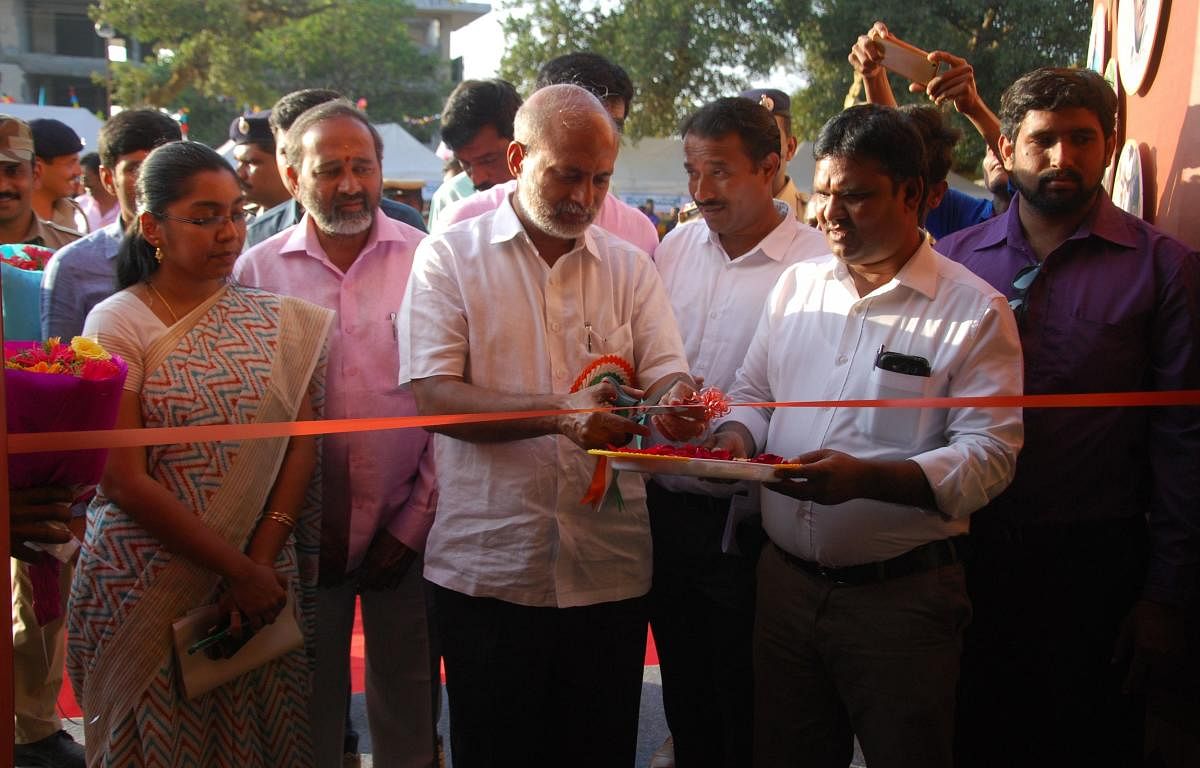 District In-charge Minister Sa Ra Mahesh inaugurates a stall of Information and Public Relations Department at Kodagu Pravasi Utsav in Madikeri on Friday.