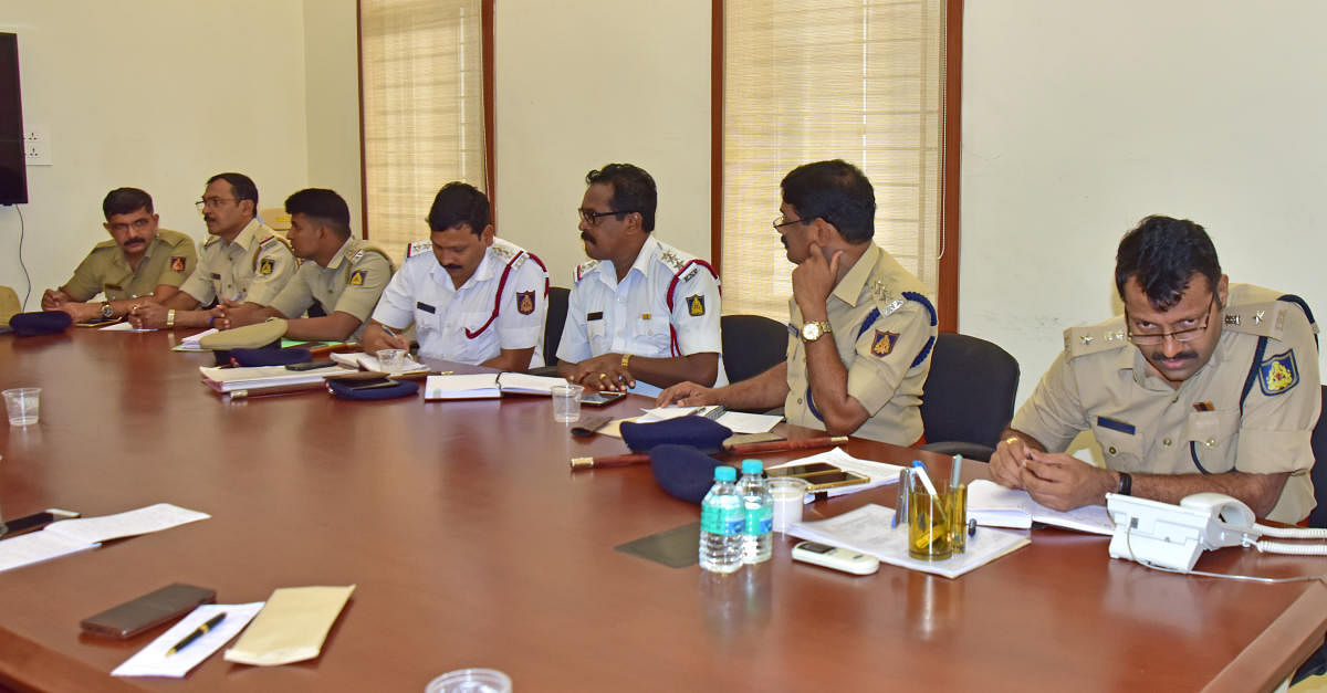 DCP (Law and Order) Hanumantharaya (right) interacts with a caller during the weekly phone-in programme organised by the Mangaluru city police commissionerate on Friday.