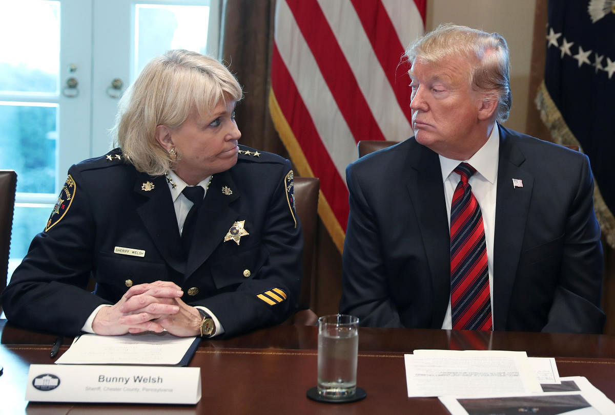 Donald Trump listens to Chester County, Pennsylvania Sheriff Bunny Welsh during a "roundtable discussion on border security and safe communities" with state, local, and community leaders in the Cabinet Room of the White House. Reuters photo.