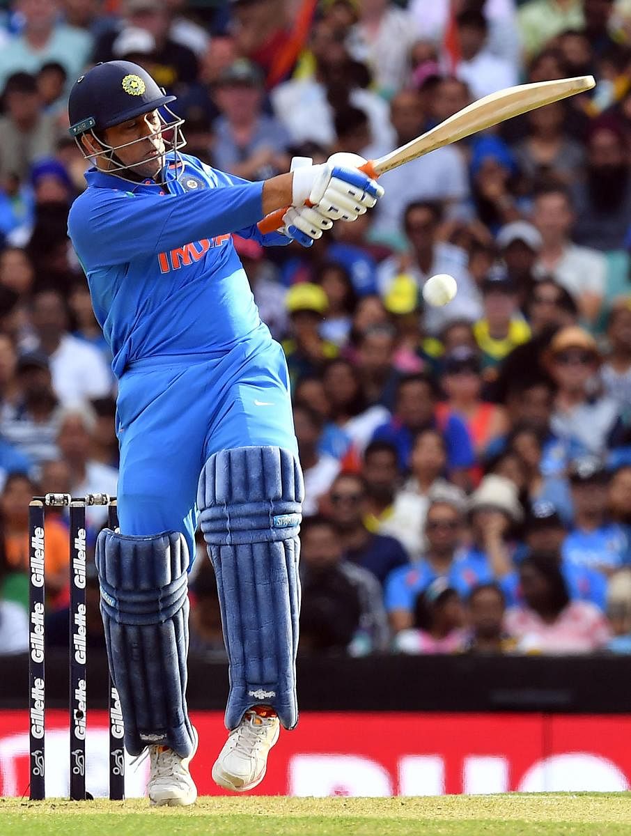 India's Mahendra Singh Dhoni pulls one to fence en route his 96-ball 51 against Australia in the first ODI in Sydney on Saturday. AFP