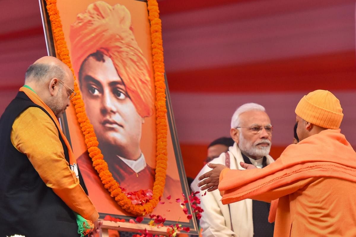 Prime Minister Narendra Modi and BJP President Amit Shah paying tribute to portraits of Swami Vivekananda during the two-day BJP National Convention at Ramlila Ground , in New Delhi. PTI