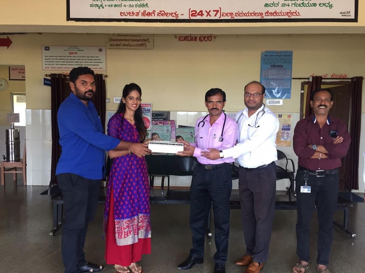 An ECG machine being handed over to Dr Shivakumar and Dr Madan Mohan at a CHC in Napoklu.