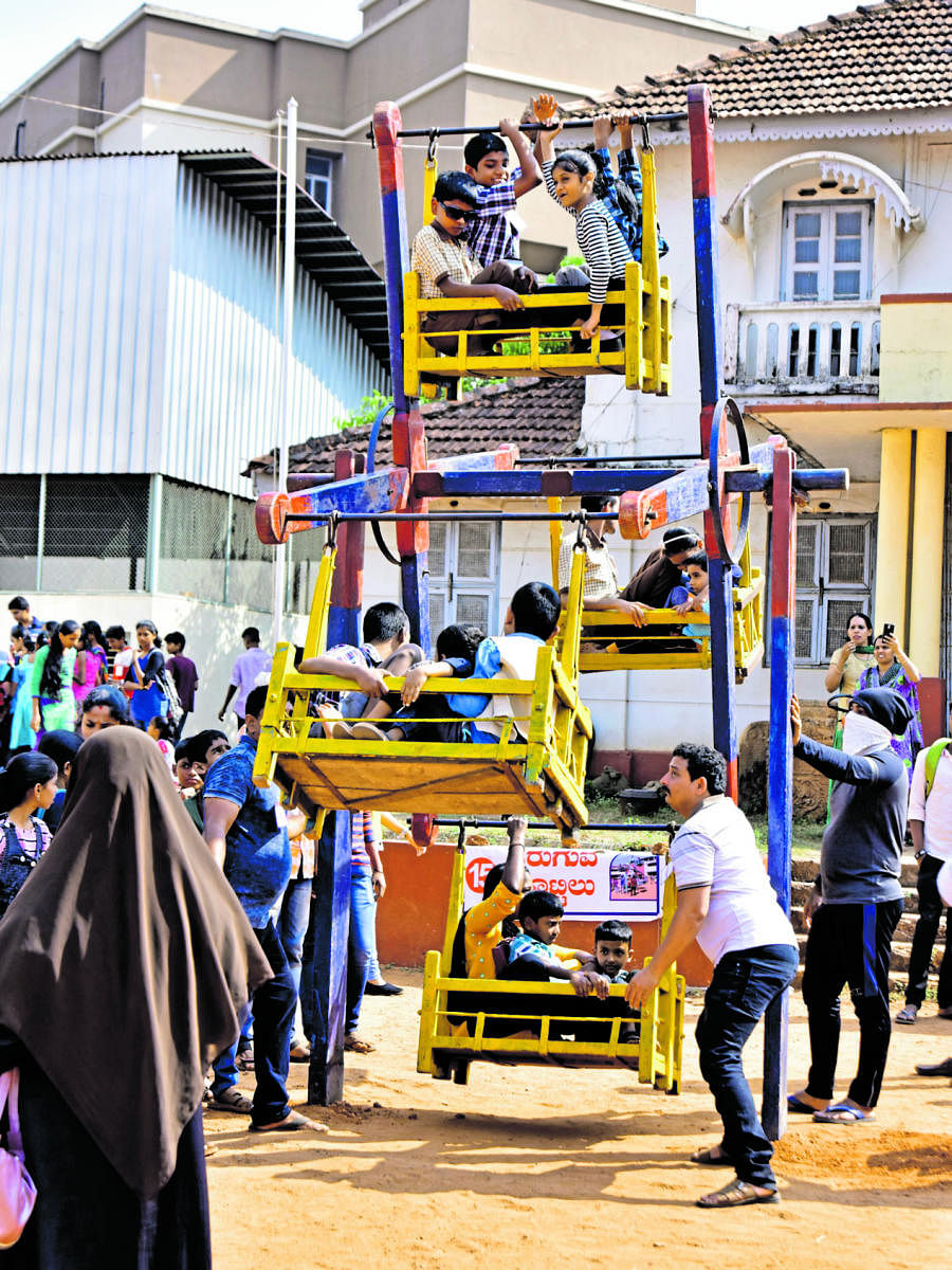 Special children enjoy free rides in the traditional small wheel at the day-long ‘Vishishtarigagi Vishishta Mela’ organised on Canara High School grounds (main) in Dongerkeri, Mangaluru, on Sunday.