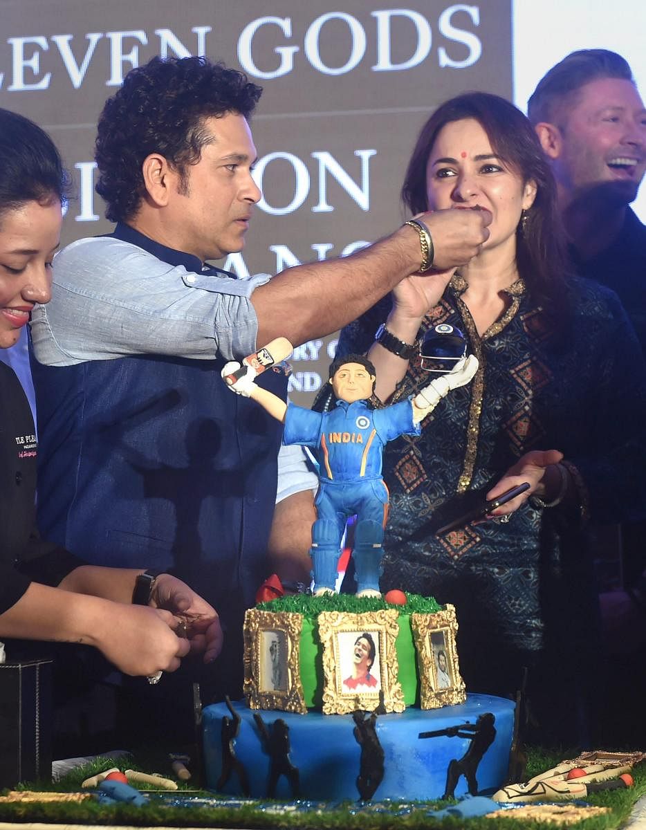 Cricket legend Sachin Tendulkar offers cake to his wife Anjali at a book launch function in Mumbai on the eve of his birthday on Monday. PTI