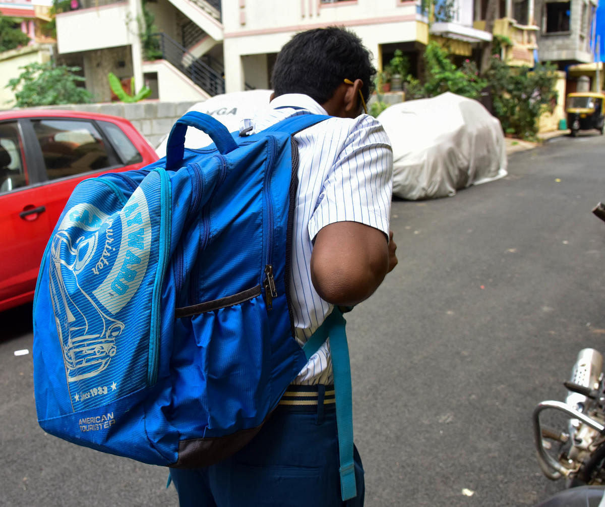 Go with Dhmetro story... School Children are carrying heavy bags, in Bengaluru. Photo/ B H Shivakumar