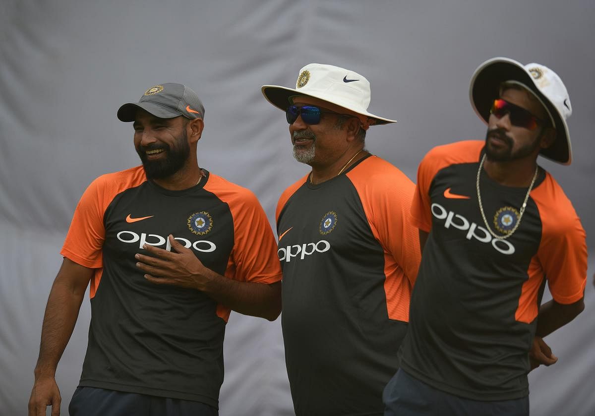 MAN WITH A GOLDEN TOUCH: India bowling coach Bharat Arun (centre) may be seen joking about quite often during 'nets' session but that has never stopped him from making keen observations of his pacers. AFP