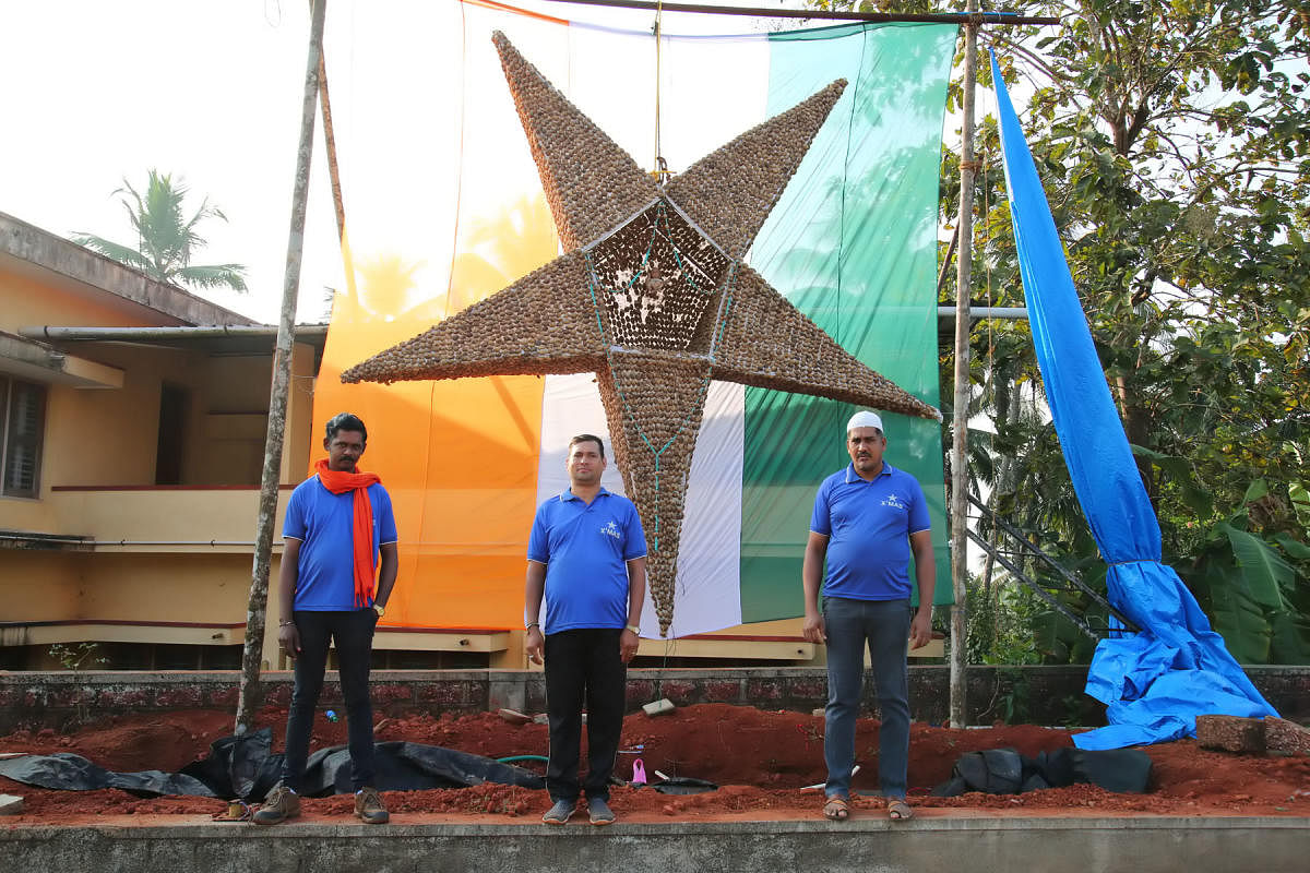 Three youth with Christmas Star at Mount Carmel Church in Shirthady.